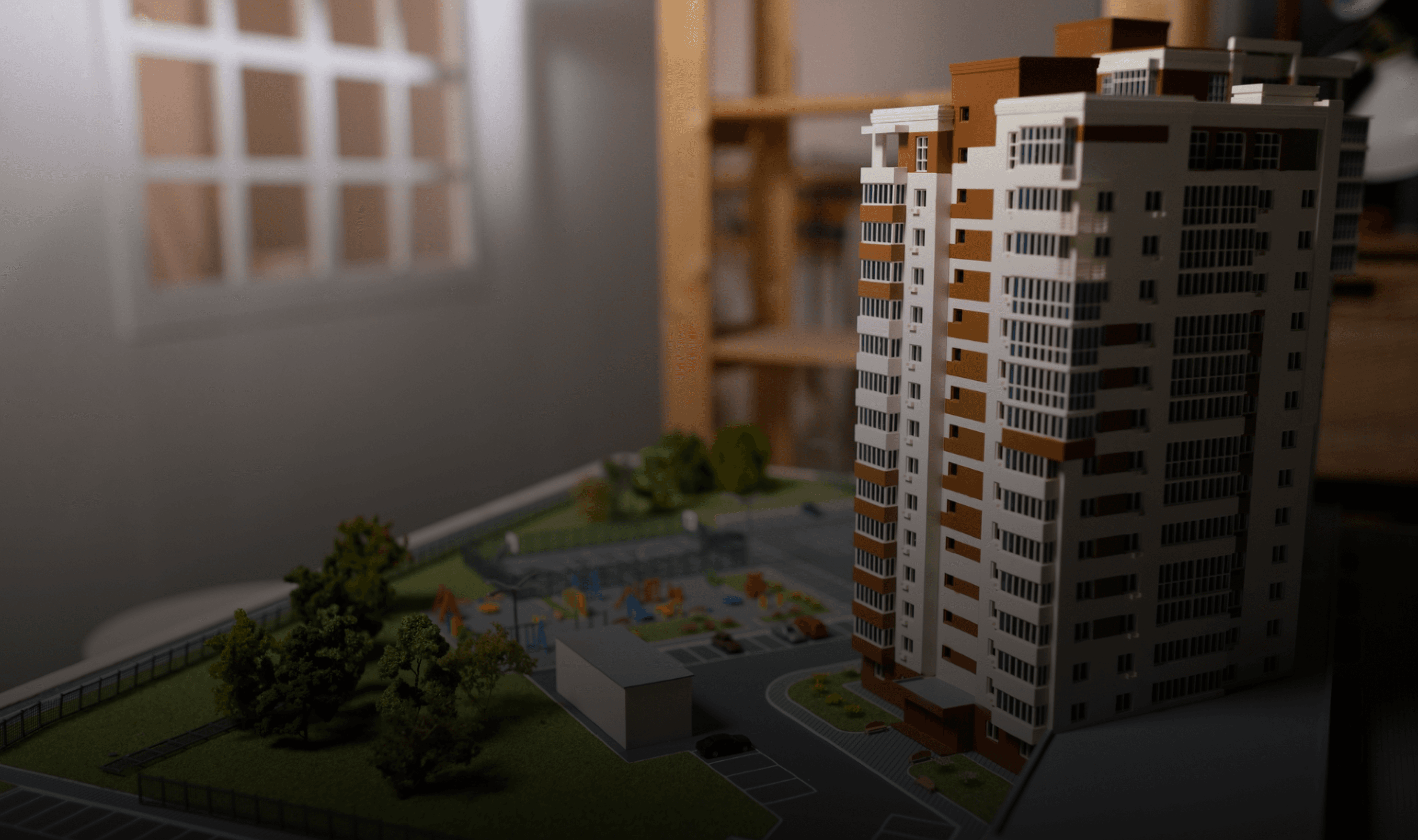 Hands holding holographic city buildings