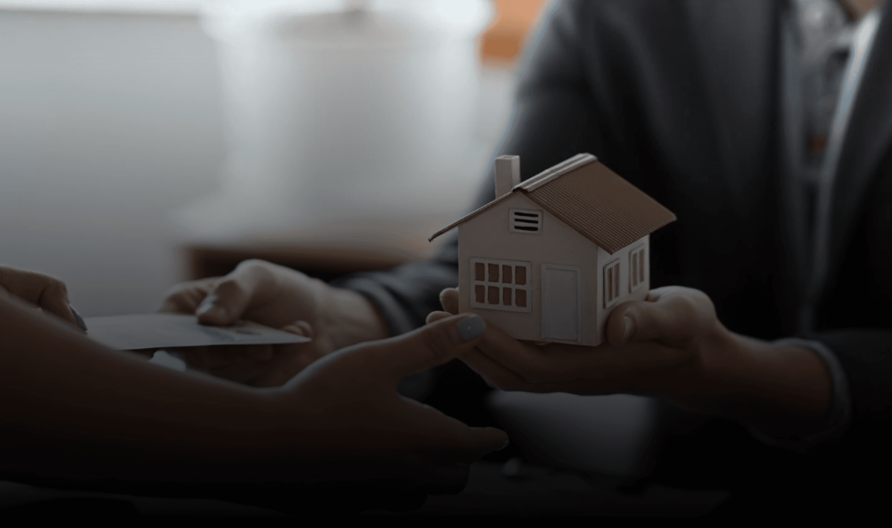 Hands holding holographic city buildings